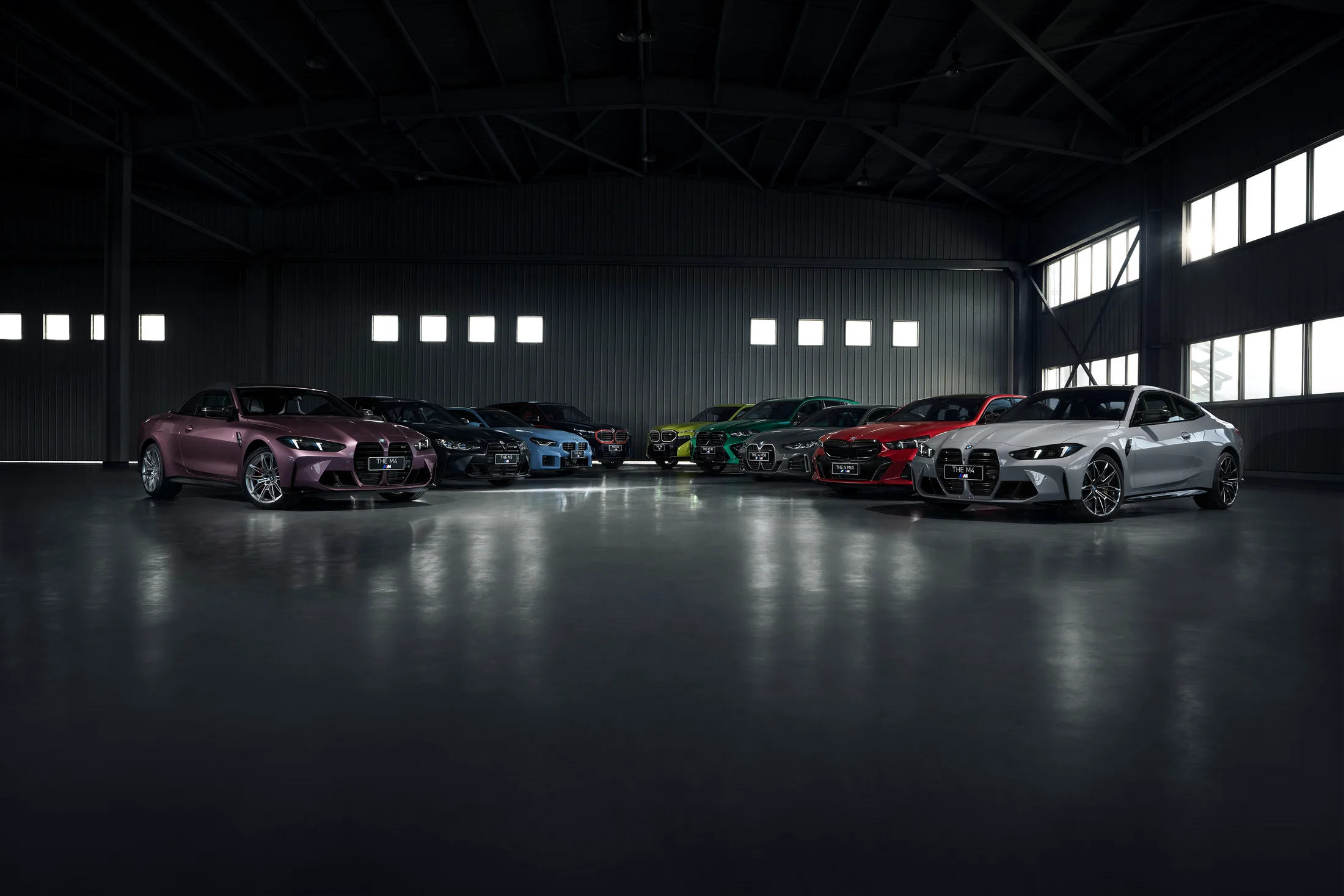 BMW M cars in a dark studio